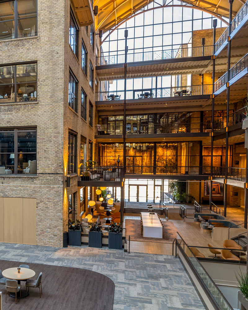 The sunlit International Market Square atrium with large windows and exposed roof trusses