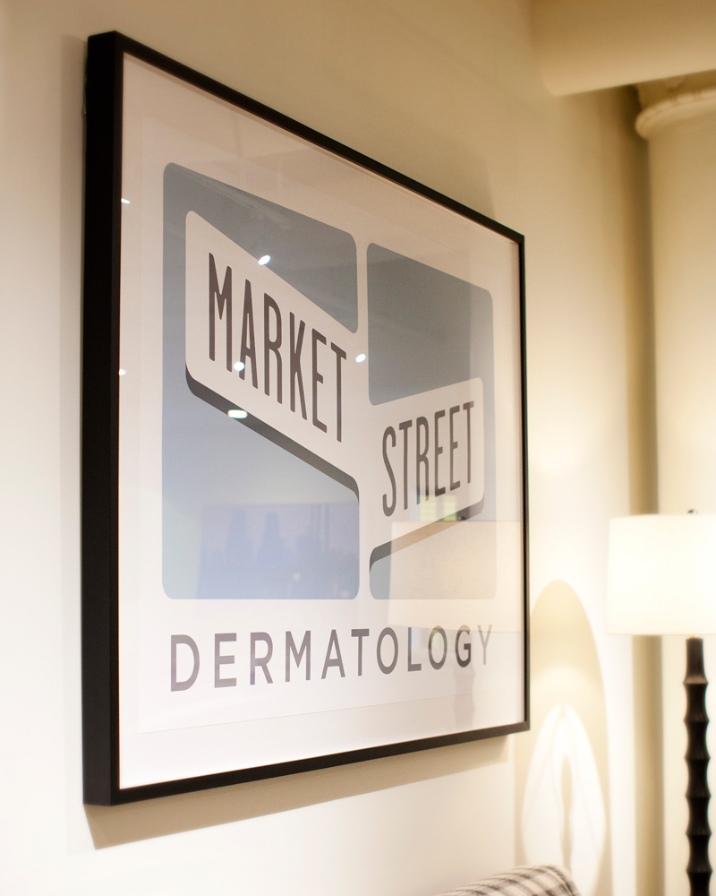 The framed Market Street Dermatology sign inside the practice